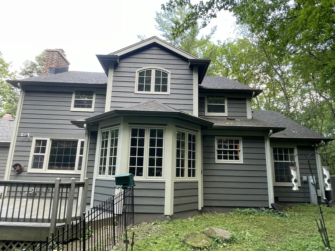 Finished dark exterior repaint with cream trim